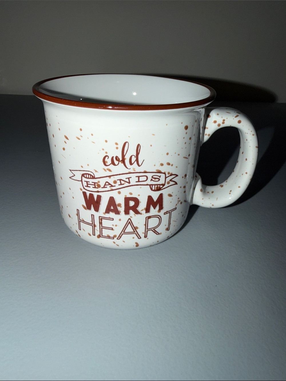 White Ceramic Mug with Brown Speckle and 'Cold Hands Warm Heart' Print